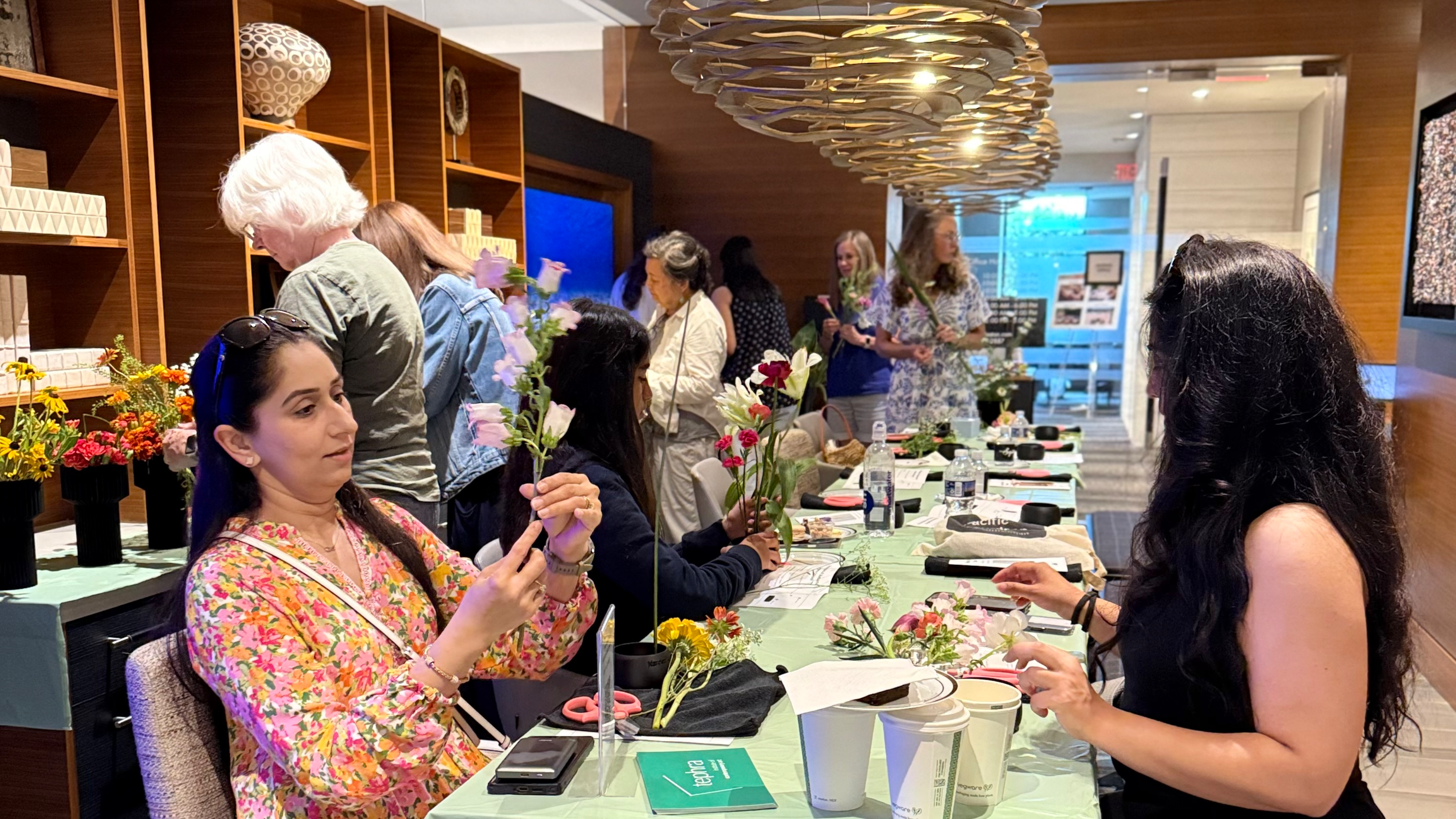 Participants in an Ikebana class creating arrangements at a Reston Town Center workshop